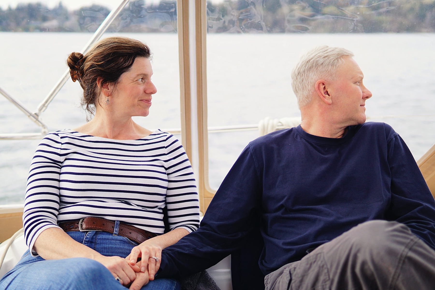 Beth and Ben seated aboard the boat, looking out across the water.
